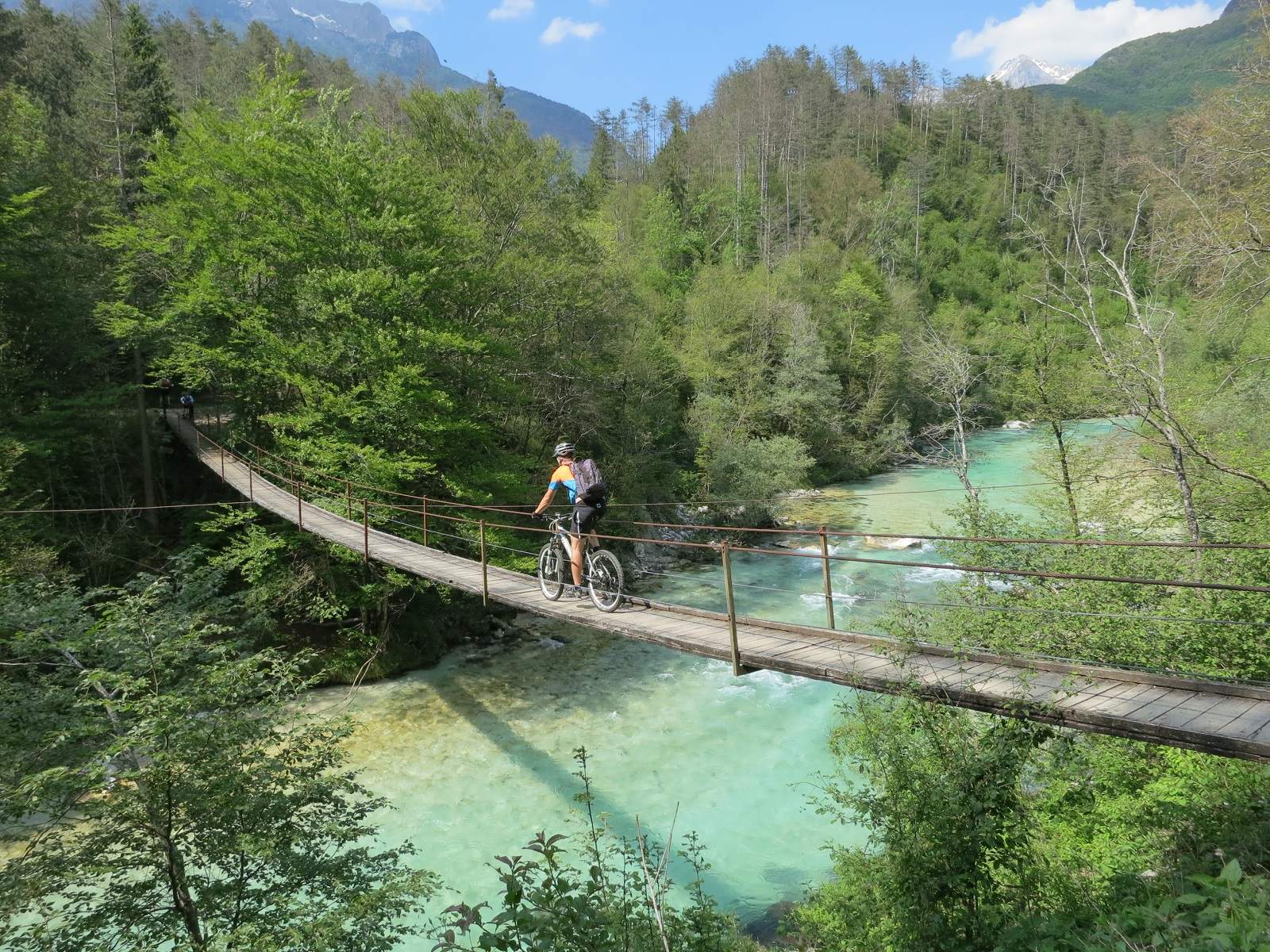 Mountainbiker fährt über Brücke im Soca-Tal bei der beitune MTB-Tour Trans-Slowenien